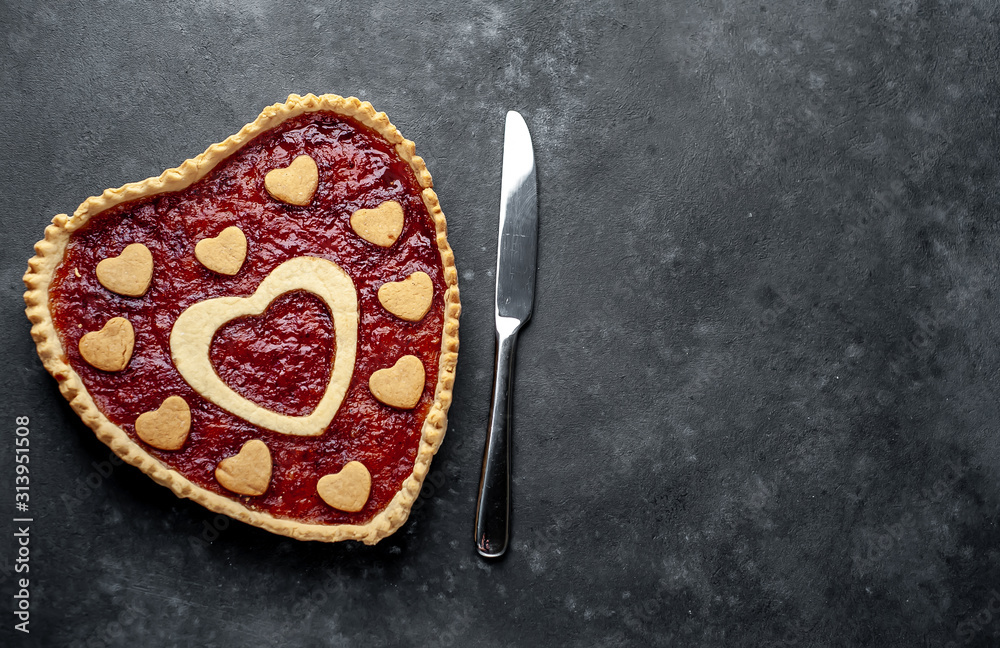 heart-shaped cake with jam on a stone background with copy space for your text. valentine's day celebration concept heart-shaped cake with jam on a stone background with copy space for your text. valentine's day celebration concept