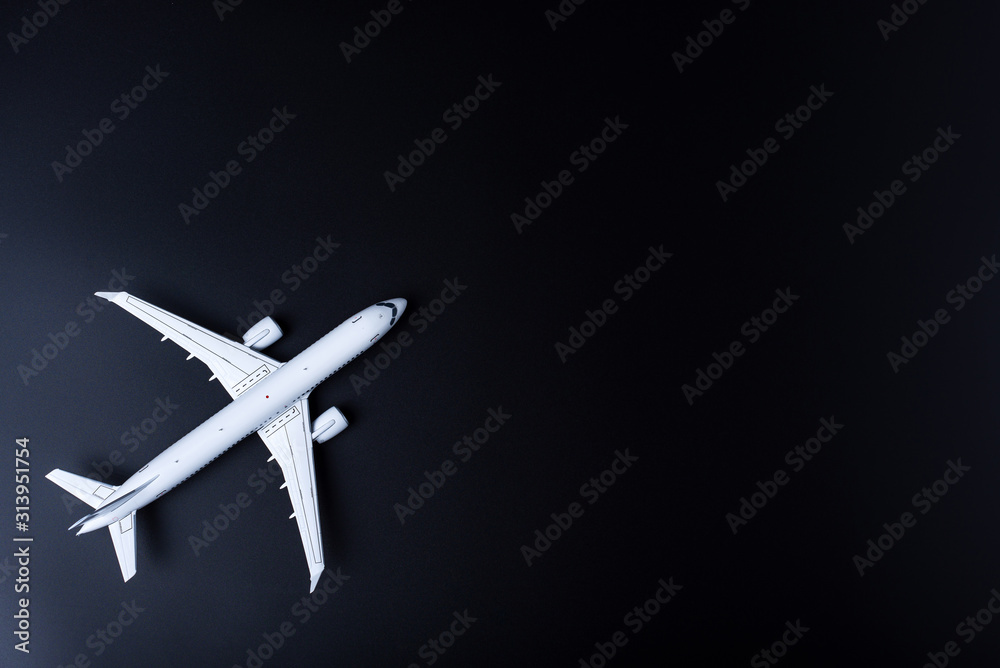 The passenger plane on black background with empty space for text. Top view, copy space The passenger plane on black background with empty space for text. Top view, copy space