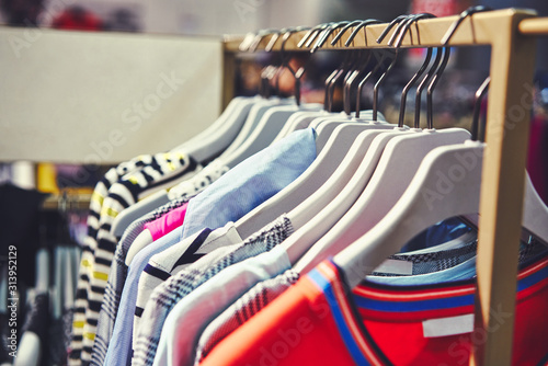 Clothes hang on a shelf in a designer clothes store. Dresses sale