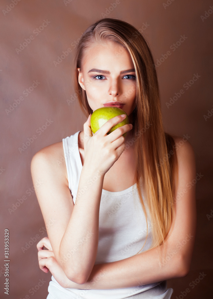 young pretty blond woman holding green apple smiling slim, lifestyle people concept young pretty blond woman holding green apple smiling slim, lifestyle people concept