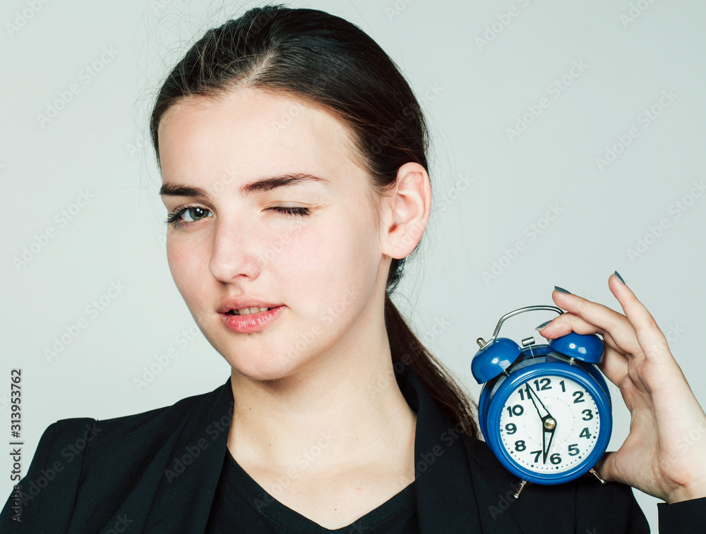 young beauty woman in business style costume waking up for work early morning on white background holding alarm clock young beauty woman in business style costume waking up for work early morning on white background holding alarm clock