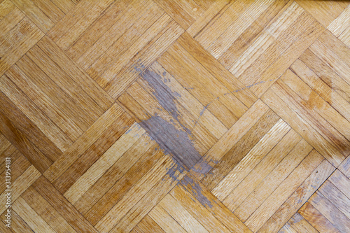 Old parquet floor with scratch marks; indoor hardwood flooring needing refinishing photo