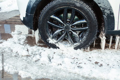 close up photo off car in iciles, a lot of water and snow, seasonal issues concept photo