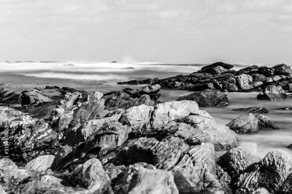 rocks on the beach long exposure monochrome