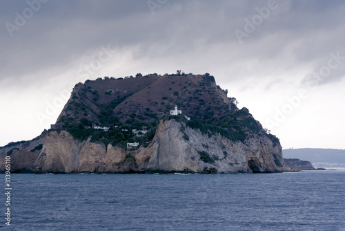 Island with lighthouse in the sea, stormy weather