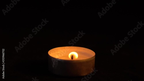 Slow motion white candles light up flames fire on isolated black background. Use in romantic dinner, warm and relax peace maditaion, use for spiritual religion church decotion and Halloween graveyard photo