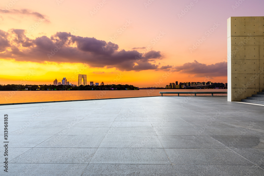 Empty square floor and modern city skyline with buildings in suzhou at night,China.