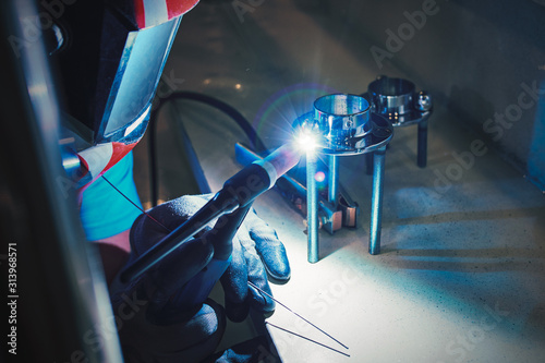 Men's hands with argon welding machine. repair pipe stainless argon welding industrial construction