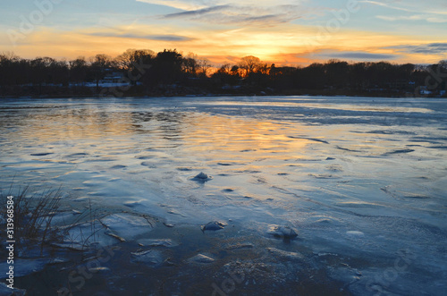 Ice-covered harbor at sunset. Setauket Harbor, Long Island. photo