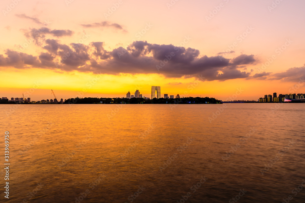 Beautiful suzhou city skyline and architecture with lake at sunset,China.