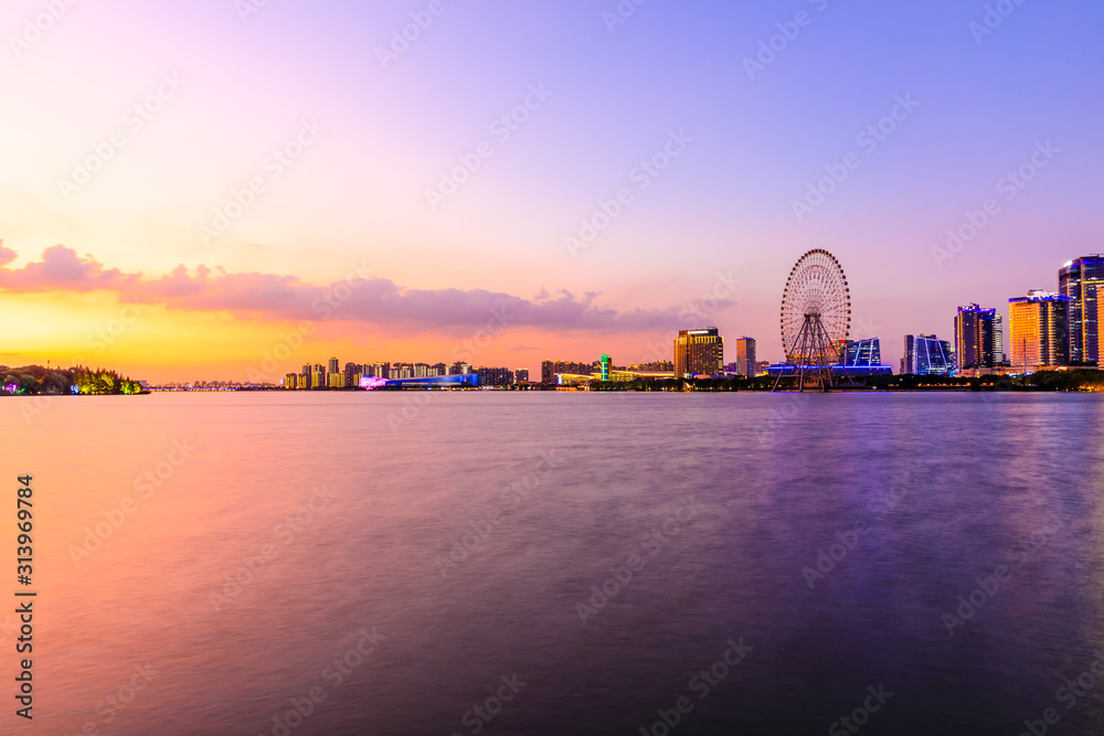 Beautiful suzhou city skyline and architecture with lake at sunset,China.