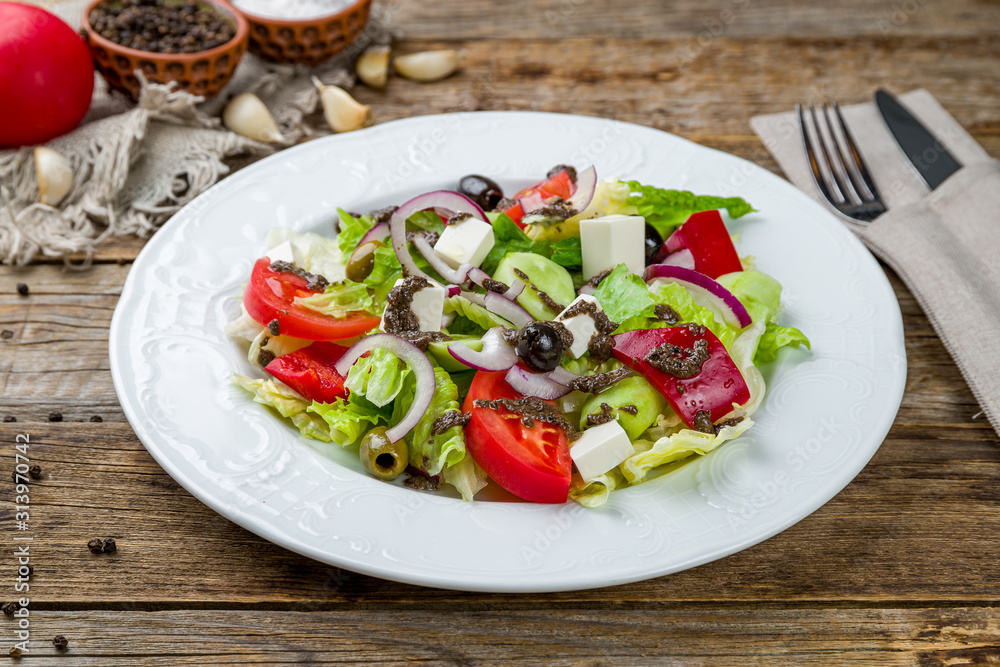 Greek salad with feta on wooden table