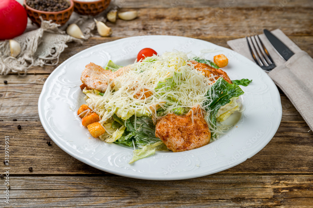 Salad caesar with chicken on white plate Salad caesar with chicken on white plate
