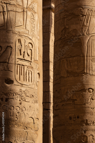 Karnak Temple, complex of Amun-Re. Embossed hieroglyphics on columns. Great Hypostyle Hall. Min is an ancient Egyptian god. Luxor Governorate, Egypt.