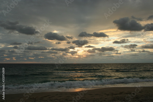 Dramatic Stormy Sky Sunset Reflected on the Ocean Waves © Alene Pierro