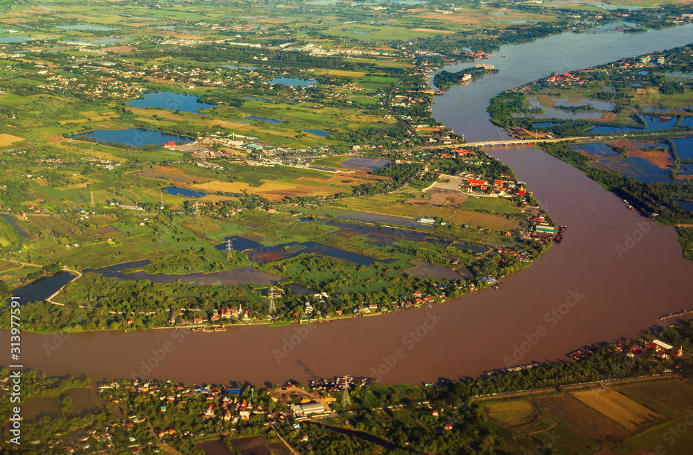 Aerial view of Chao Phraya River. Rural area and agricultural area at sunset. Houses in village and trees in forest in Bangkok City, Thailand Aerial view of Chao Phraya River. Rural area and agricultural area at sunset. Houses in village and trees in forest in Bangkok City, Thailand