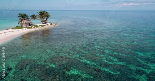 Aerial low over caribbean reef and snorklers next to small tropical island, Cayo Timon photo