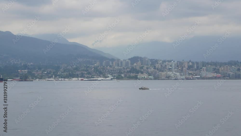 Small cruise ship (ferry boat) while sailing in Vancourver bay in British Columbia,Canada. City view with big lake and boat in the lake Small cruise ship (ferry boat) while sailing in Vancourver bay in British Columbia,Canada. City view with big lake and boat in the lake