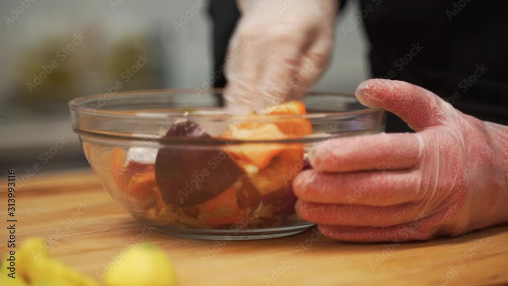 Mixing the fresh cut vegetables in seasoning. The mix includes bell peppers, squash and an array of aromatic spices. Mixing the fresh cut vegetables in seasoning. The mix includes bell peppers, squash and an array of aromatic spices.