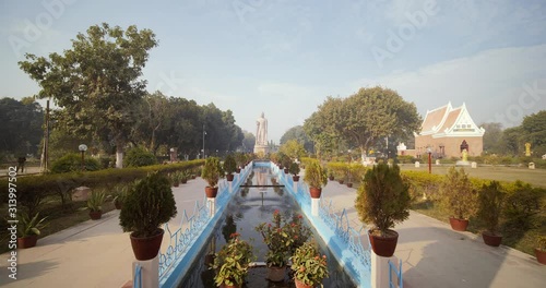 Zoom in shot of Buddha statue and garden in Sarnath temple in Varanasi, Uttar Pradesh, India