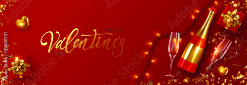 Valentines Day. Festive Romantic background. Xmas design with realistic red bottle of champagne and wine, two glasses, sparkling lights garland, gift box, glitter gold confetti. Flat lay, top view.