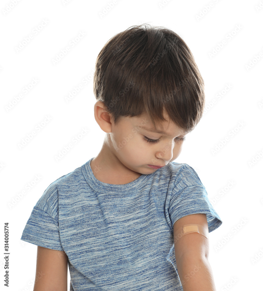 Little boy with sticking plaster on arm against white background Little boy with sticking plaster on arm against white background