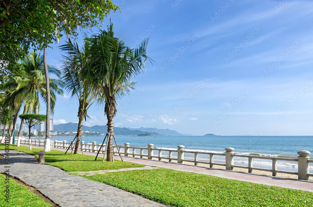 Obraz premium Wonderful beach in Nha Trang city. Palm trees, clear sea and long sandy beach. Vietnam. Beautiful seascape