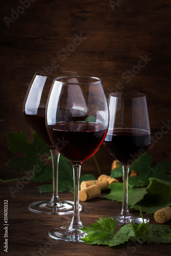 Wine glass. Selection of red wines on wine tasting. Dry, semi-dry, sweet red wine on old wooden table background. Copy space