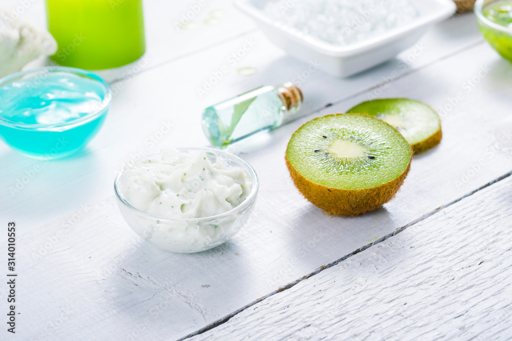 beauty products with kiwi fruit ingredient on white wooden table beauty products with kiwi fruit ingredient on white wooden table