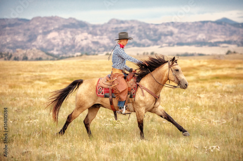 Cowgirl on Buckskin photo