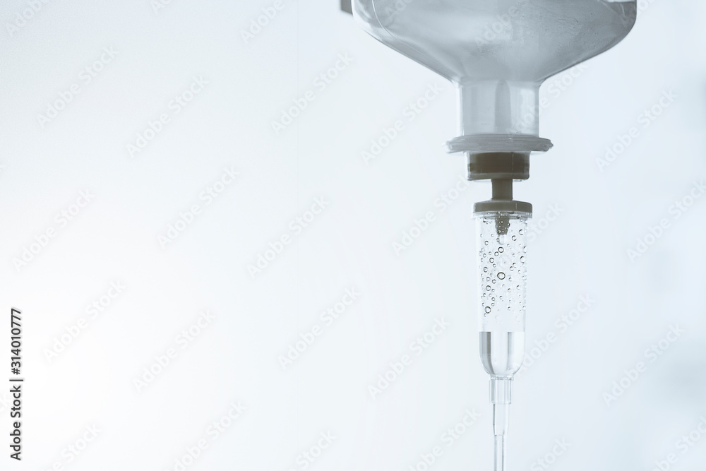 Close-up saline solution drip for patient and infusion pump in hospital, Liquid saline is slowly dripping drops of drugs, Copy space Close-up saline solution drip for patient and infusion pump in hospital, Liquid saline is slowly dripping drops of drugs, Copy space