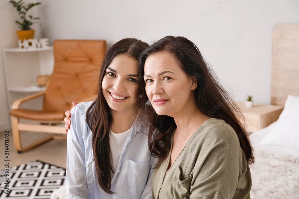 Mature woman and her adult daughter spending time together at home Mature woman and her adult daughter spending time together at home