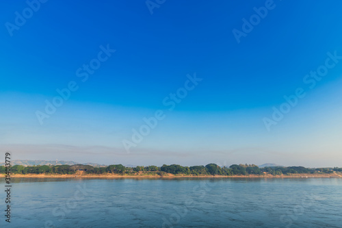 Beautiful early morning sunrise air atmosphere bright blue sky background abstract clear texture with white cloud of Mae Khong river