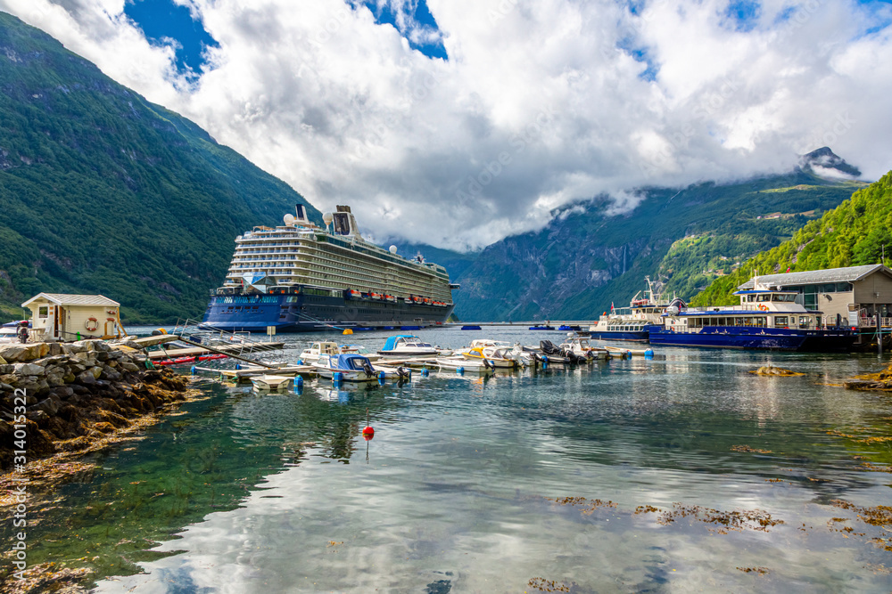 Cruise ship be anchored at Geiranger harbor in Norway in summer