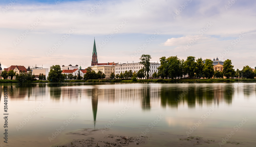 Cityscape of historic centre of Schwerin and Burgsee lake, Germany. Long exposure