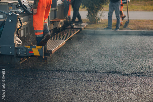 Asphalt paving. Paver machine and road roller. New road construction.