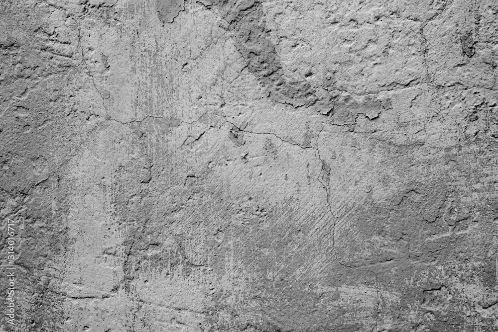Fototapeta premium Texture of a concrete wall with cracks and scratches which can be used as a background