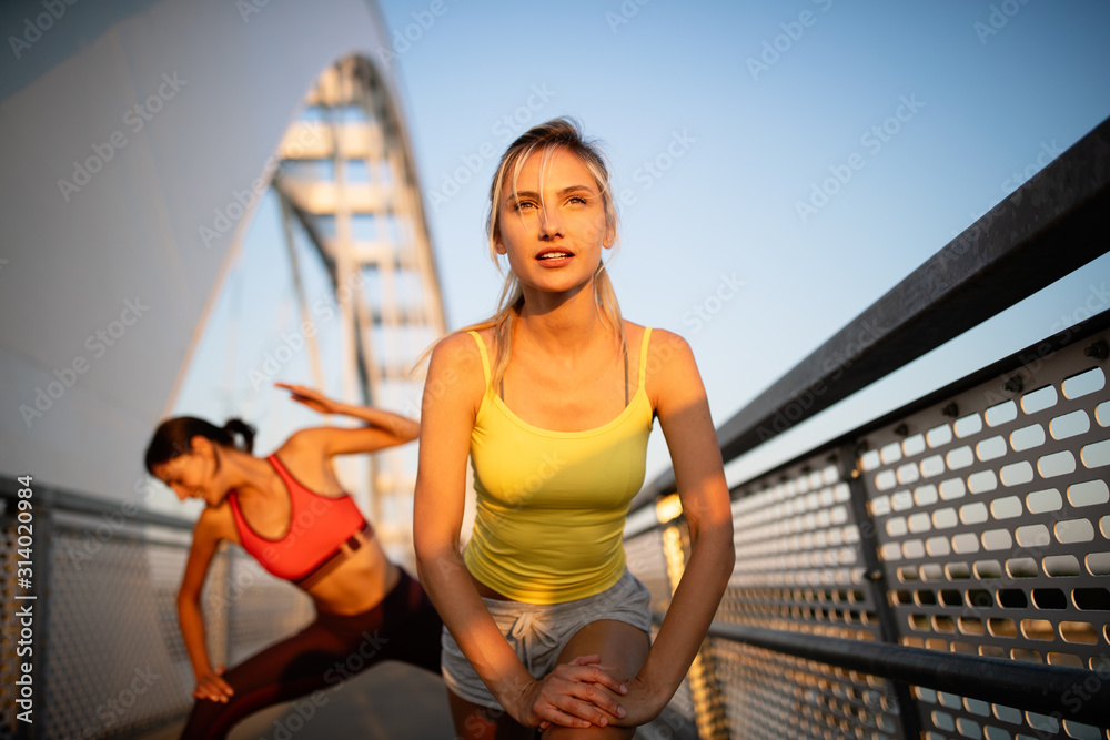 Beautiful women working out in a city. Running, jogging, exercise, people, sport  concept Stock Photo