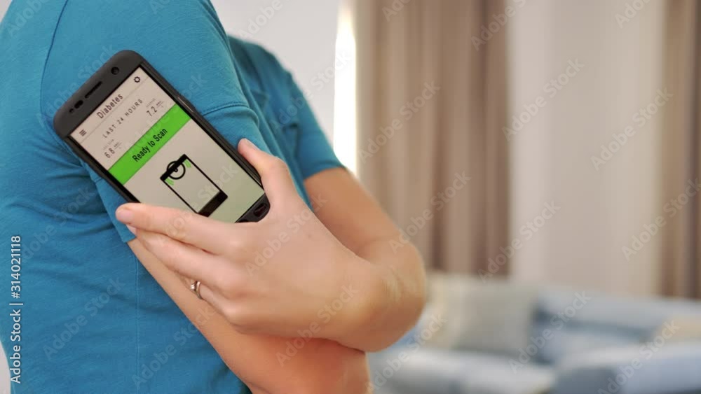 woman with diabetes checking monitoring  blood glucose using smartphone app 