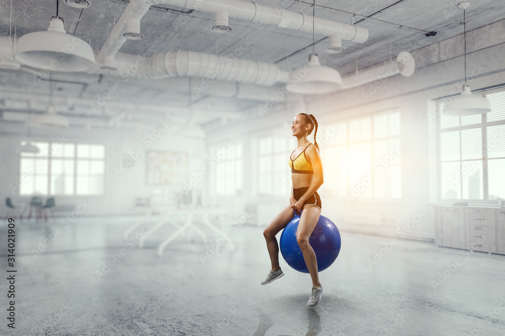 Obraz premium Sporty woman on fitness ball. Mixed media