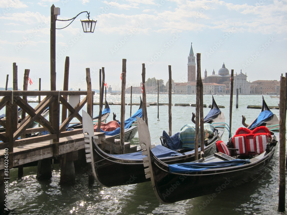 Traditional italian gondolas parking near berth.