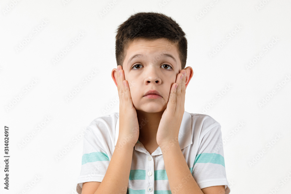 offended sad little child boy in striped t-shirt on white background. Human emotions and facial expression offended sad little child boy in striped t-shirt on white background. Human emotions and facial expression
