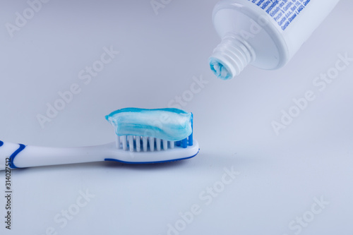 Toothbrush with colored toothpaste, care for the oral cavity and teeth, vector.