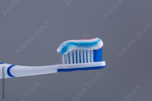 Toothbrush with colored toothpaste, care for the oral cavity and teeth, vector.