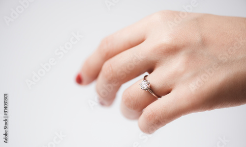 Close up of an elegant engagement diamond ring on woman finger