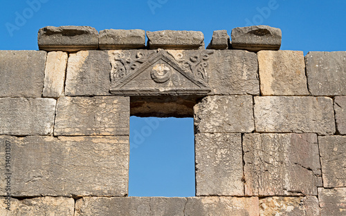 basalt stone window and beautifully carved lintel of the ancient synagogue at baraam national park in israel photo