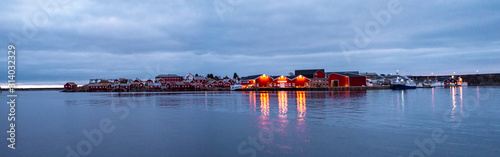 village reflection on water  in the northern sea cold winter frame, night view, blue hour