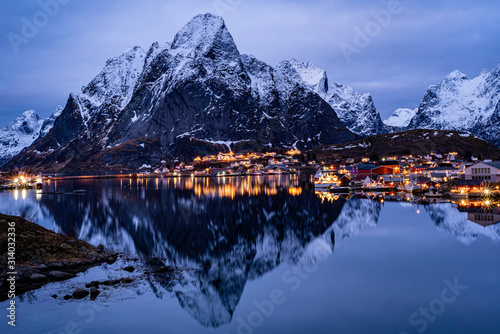 village reflection on water  in the northern sea cold winter frame  night view  blue hour