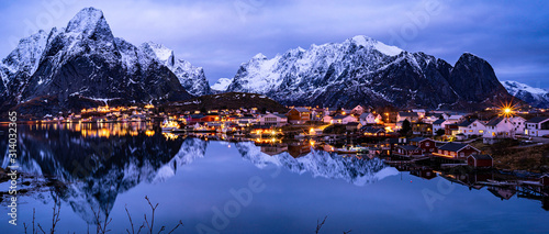 village reflection on water  in the northern sea cold winter frame, night view, blue hour