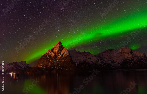 northern lights, green waves ,stars sky reflection on water